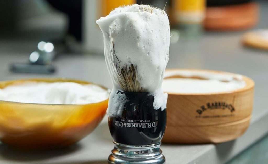 A shaving brush covered in shaving foam