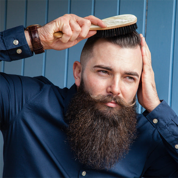 A man brushing his hair