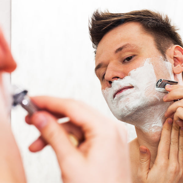 A man shaving in the mirror